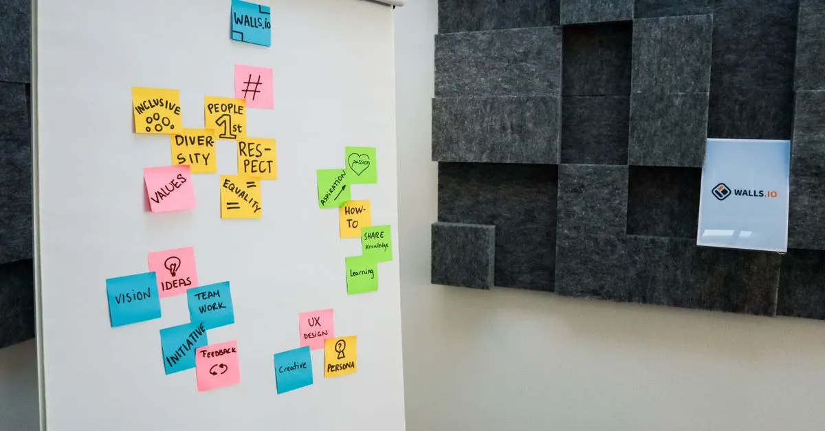 Colorful sticky notes on a whiteboard in an office setting, promoting creativity and collaboration.