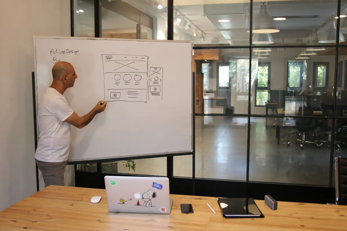 Web designer sketching a website layout at a desk