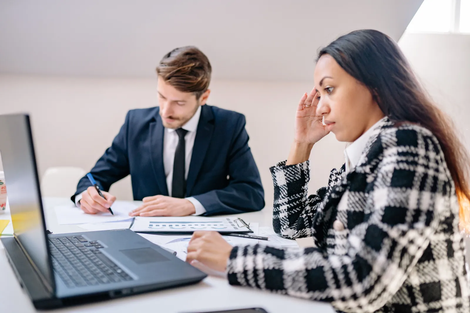 Business team working on laptops in a modern office