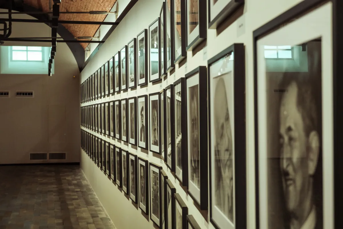 Wall of framed photographs in a gallery